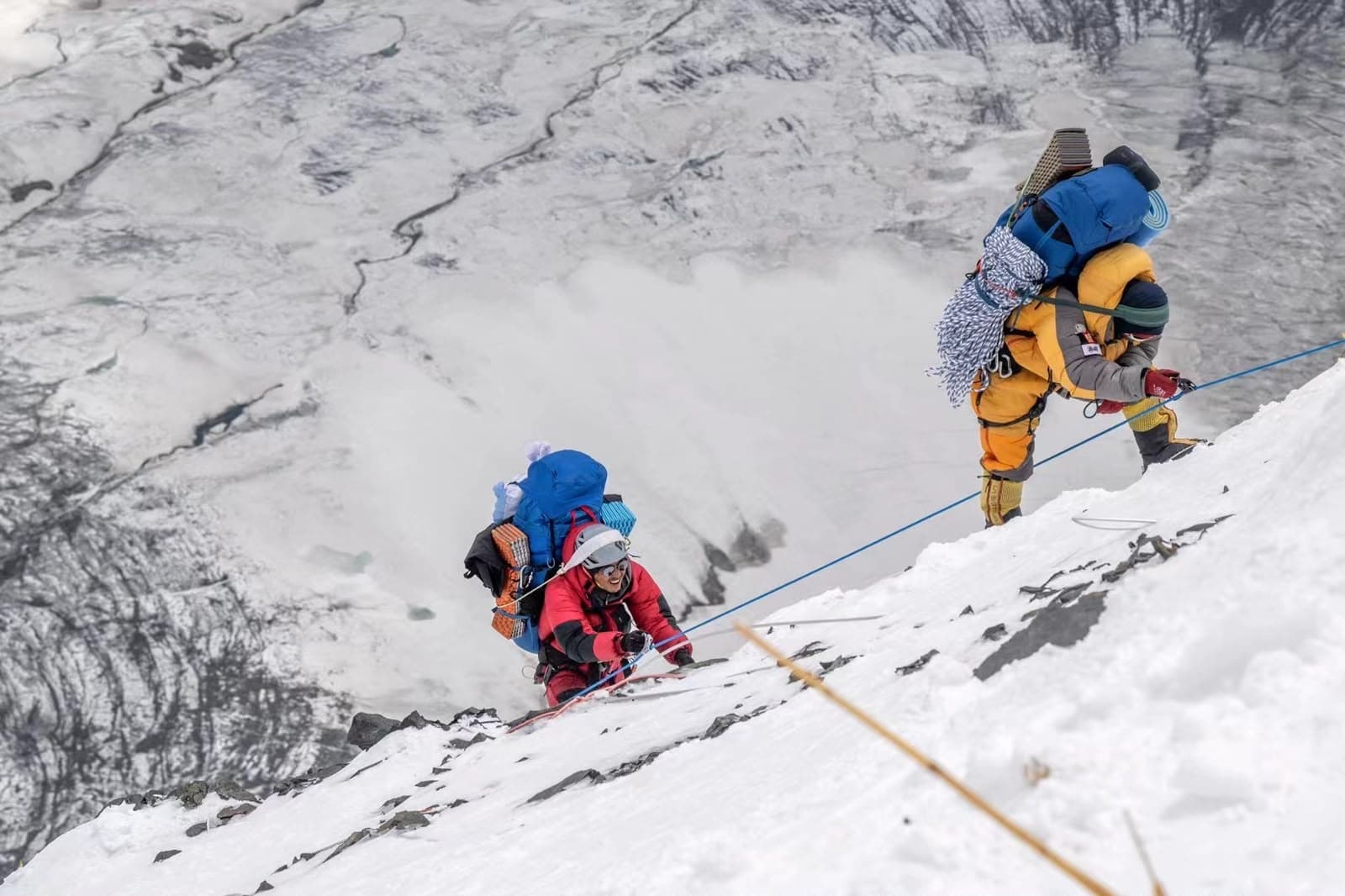 Climbers ascending a snowy Himalayan slope on a guided expedition